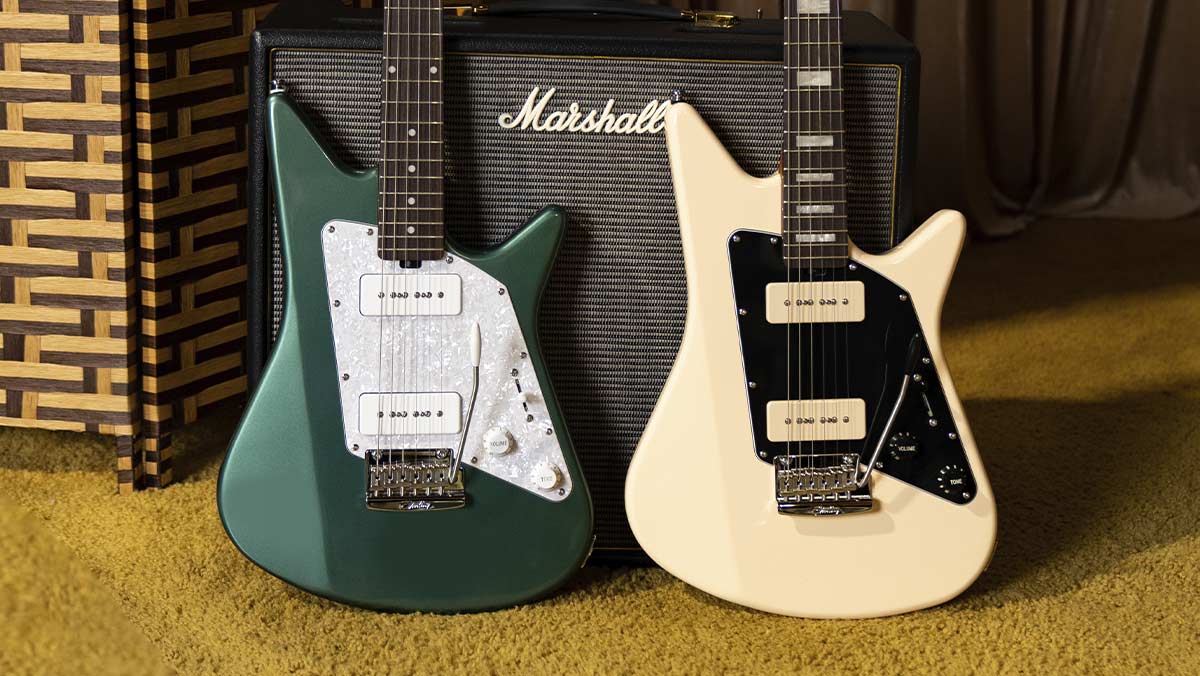 Two electric guitars in front of an amp