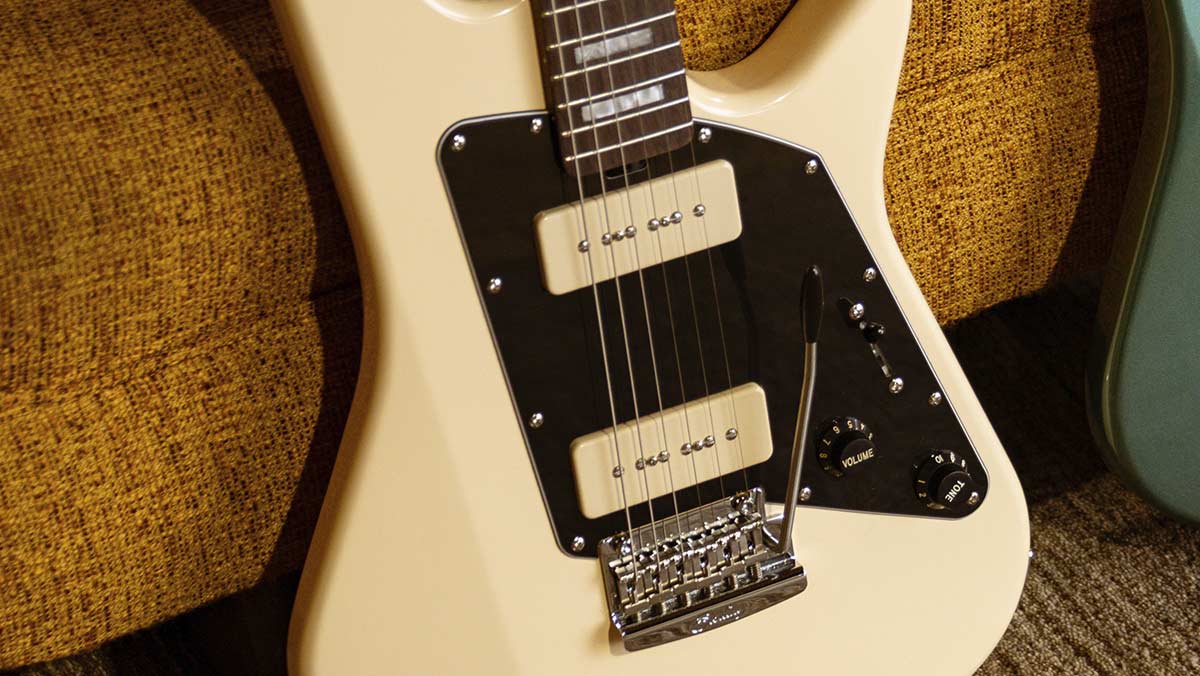 Closeup of a creme colored electric guitar