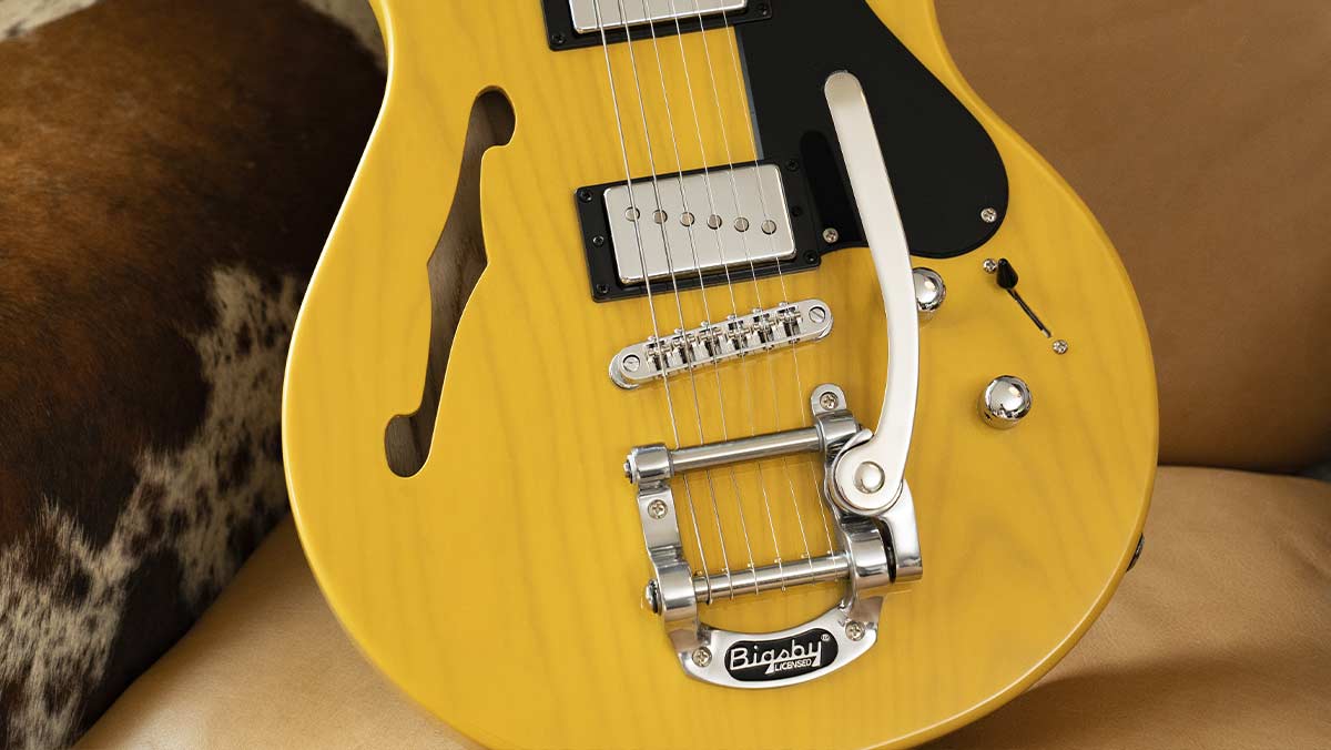 Closeup of a chambered electric guitar with a bigsby bridge